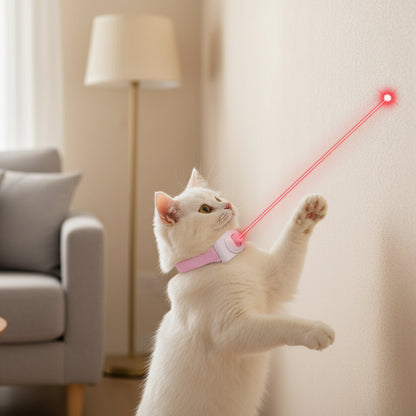 White cat playing with a laser pointer against a blue background